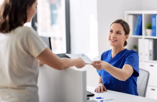foreign woman applying for a health card from a female employee's wife