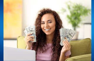 Woman with her hands full of dollar bills