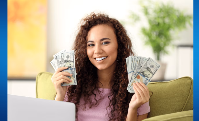 Woman with her hands full of dollar bills