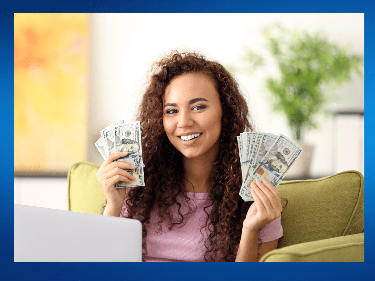 Woman with her hands full of dollar bills